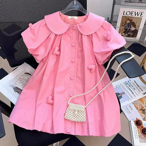 Vestido Infantil Rosa com Aplicações de Coração e Bolsa de Pérolas